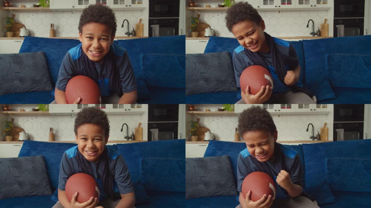 兴奋可爱的黑人男孩在电视上观看美式足球，庆祝达阵