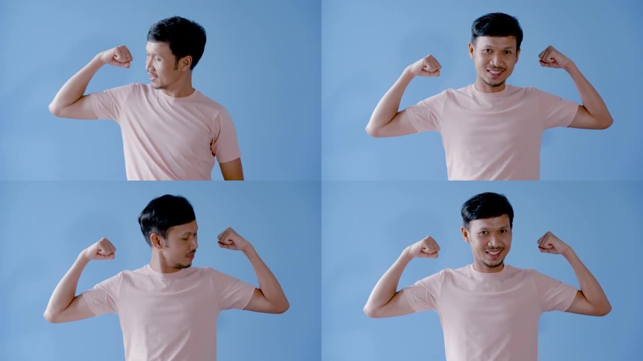 4K 50fps，亚洲男子，小胡子，举起手臂展示他的肌肉显示力量和强壮的身体。肢体语言。显示左臂和右