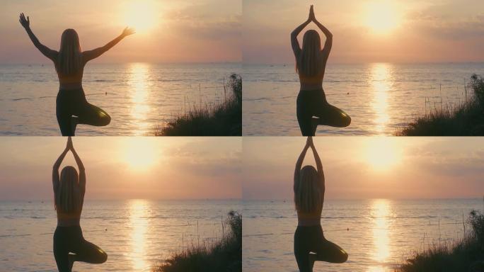 女人在夏天的日落中有海洋背景在做瑜伽。热身，健康生活，放松和户外运动。保健，真实性，平衡感和镇定感。