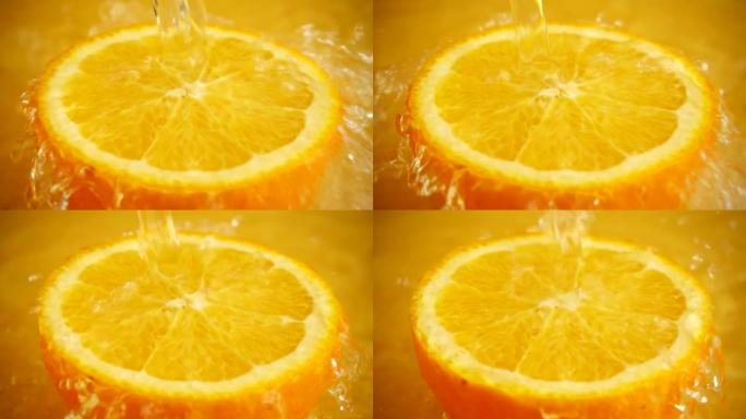 橙色背景上的水柱中的一半橙色。慢动作。