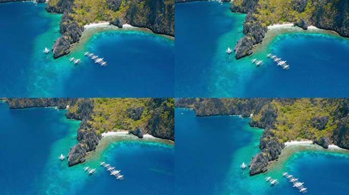 停泊在Miniloc岛秘密泻湖附近的潜水船的鸟瞰图。巴拉望爱尼多。菲律宾。奇异的石灰岩岩层和带有珊瑚