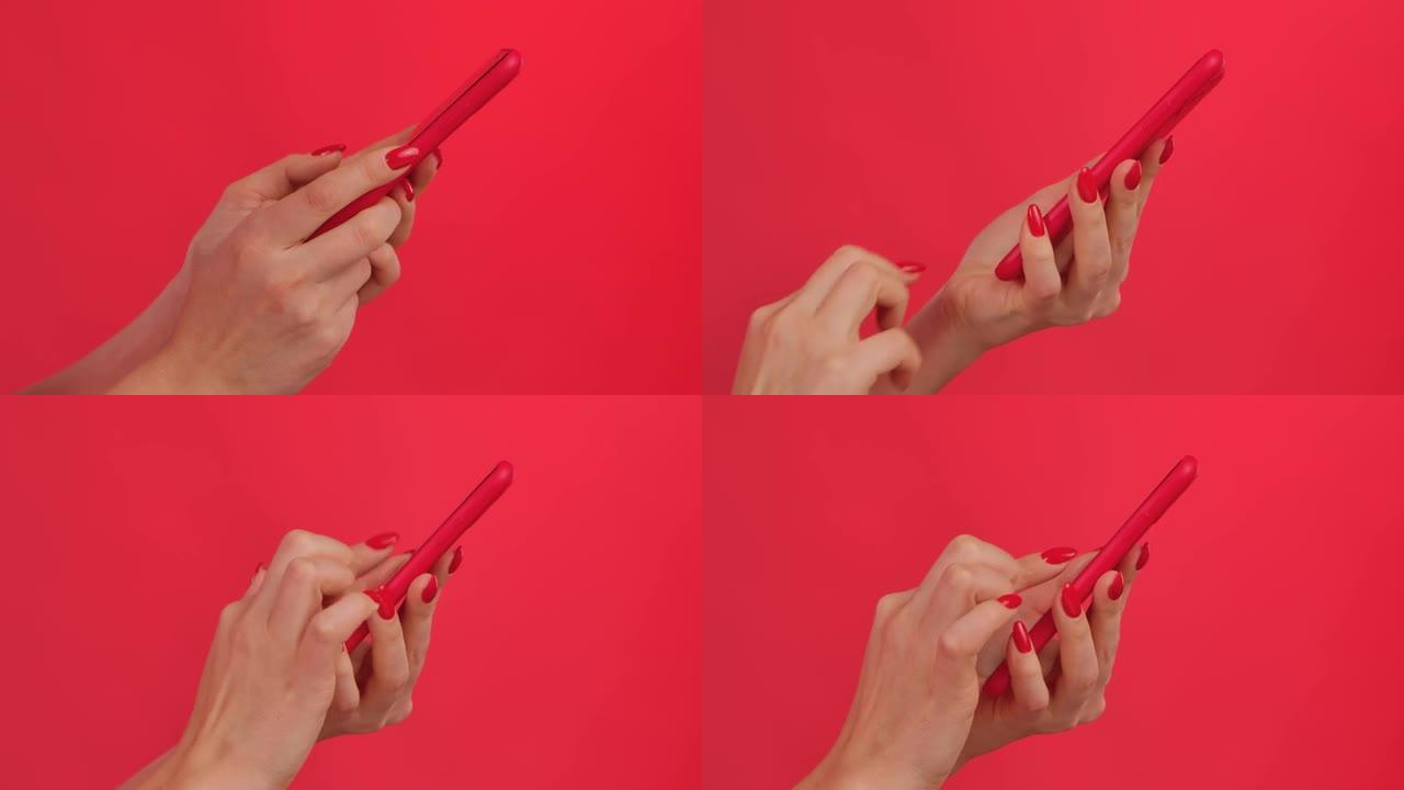 女性双手在红色工作室背景下的智能手机上发短信。手指触摸触摸屏，滑动，点击，滑动和点击。女人浏览内容并
