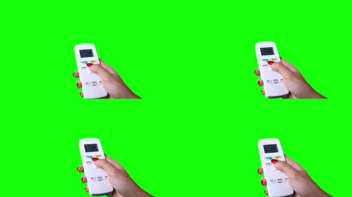 女性手用空调控制器改变温度的视频镜头，绿屏背景拍摄，4k分辨率拍摄