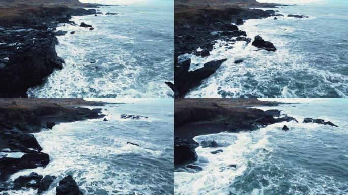 冰岛的海洋海岸，海浪在岩石上破裂，大海侵蚀火山岩，鸟瞰图
