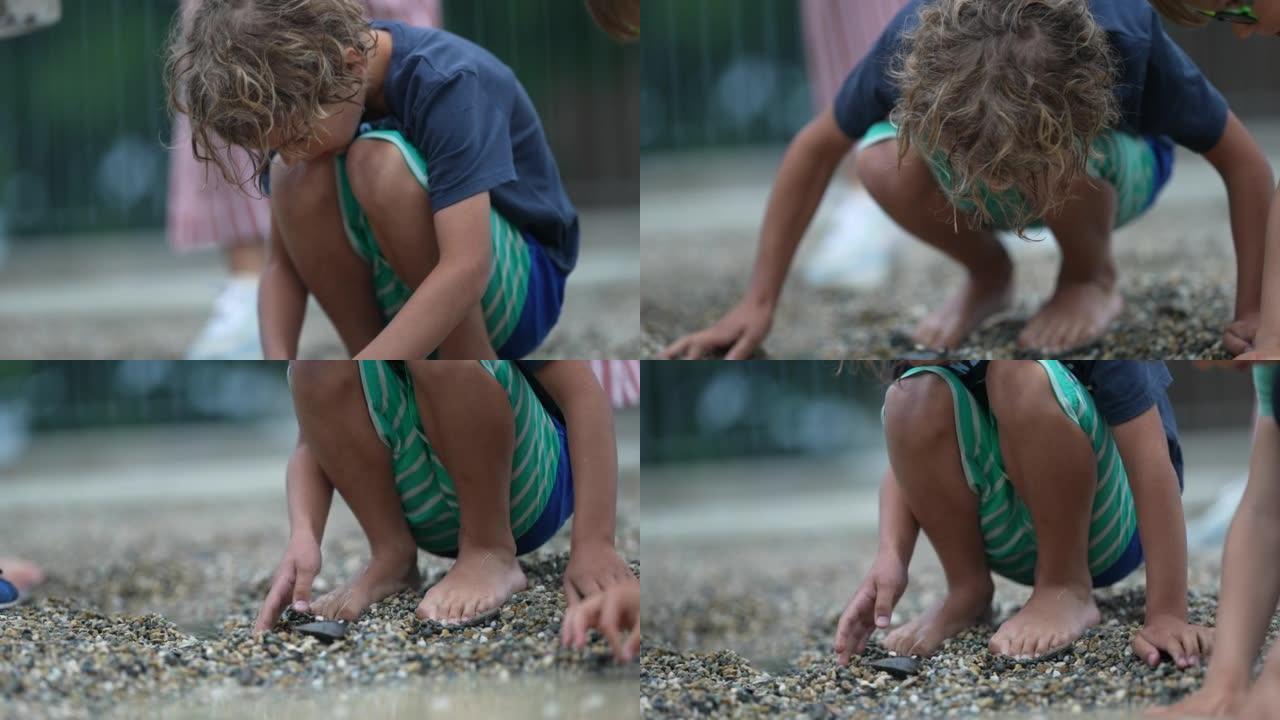 小男孩在海滩或公园寻找岩石