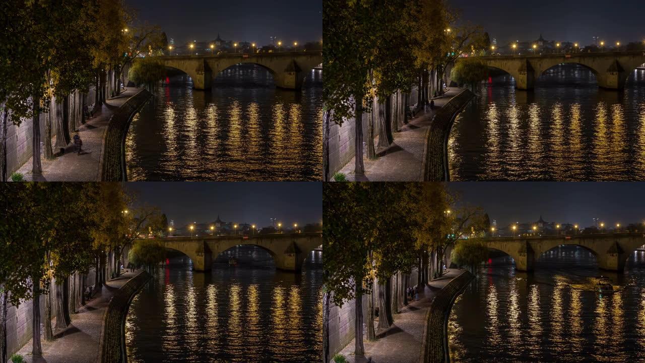 塞纳河码头在巴黎人民步行桥的夜晚灯光和倒影