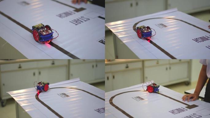 在实验室中测试在路线上运行的具有传感器响应的机器人机器人汽车。建筑师设计电路和会议共享技术思想和协作