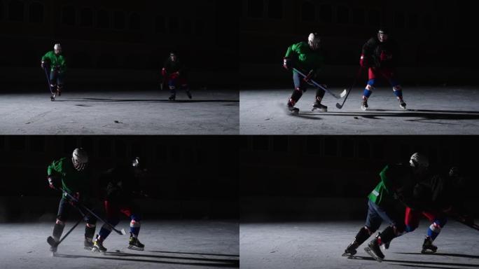 两名身穿制服和头盔的男子在冰场上滑冰，碰撞，运球并击中冰球。职业曲棍球运动员在带有聚光灯的黑暗溜冰场
