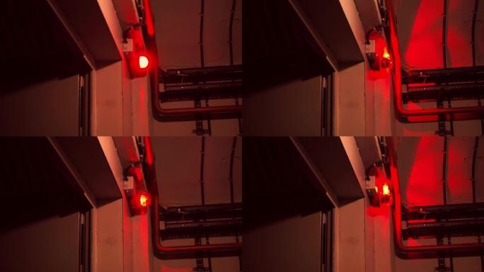 房间里的报警系统。门上的红色燃烧警报器。红灯在房间的角落里旋转