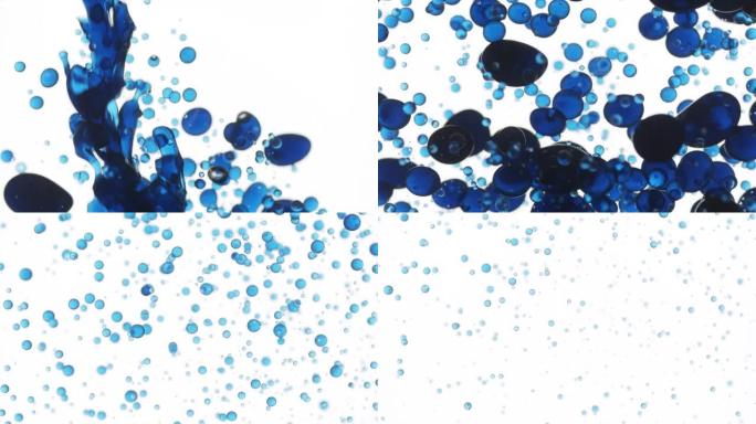 将蓝色的tansy油倒入水中，产生蓝色气泡