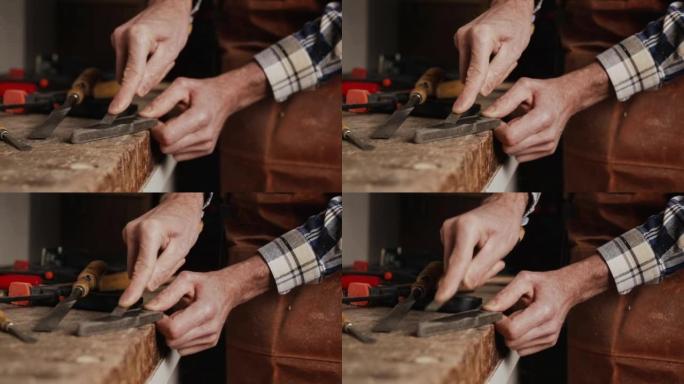 木匠磨凿子。木工车间用手工工具进行木工加工。木雕概念。高质量4k镜头