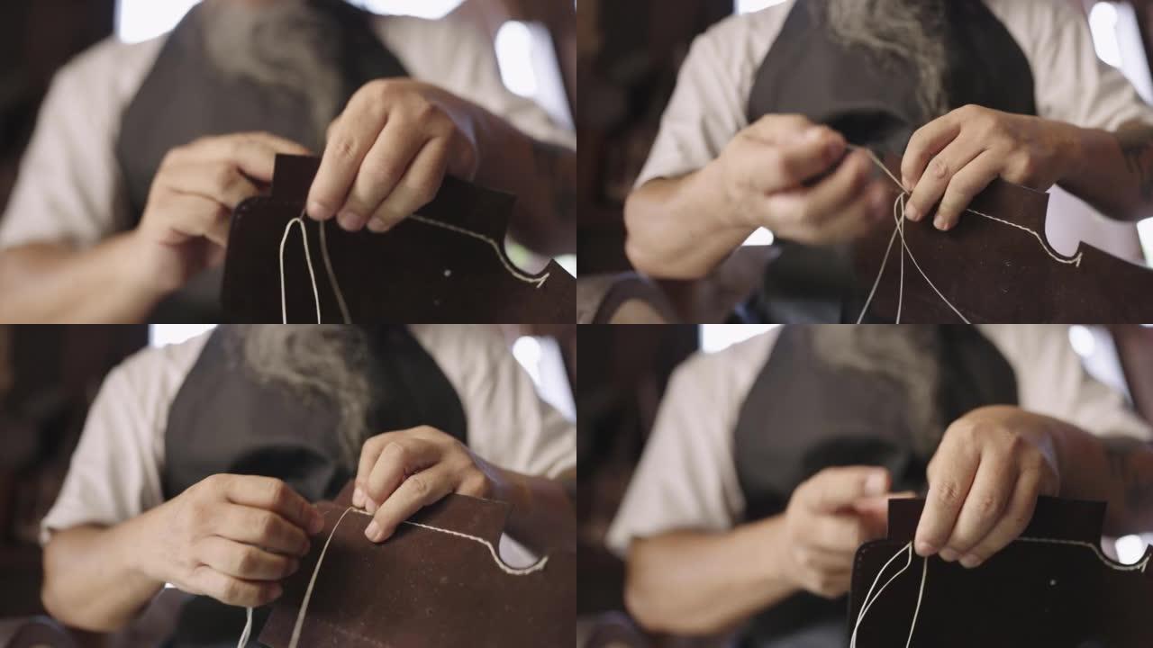 一个男人手工缝制皮革产品的特写镜头。
