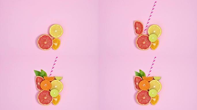 切成薄片的柑橘类水果使果汁玻璃形状与柔和的粉红色主题的稻草。停止运动平铺