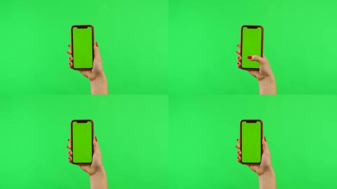 女人在垂直位置拿着带有绿色背景的工作区模拟屏幕的手机。女性手触摸、点击、滑动和滑动。手势包。广告区域