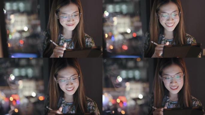 现代的y世代女商人戴着眼镜，在晚上用数码平板电脑书写和安排日程