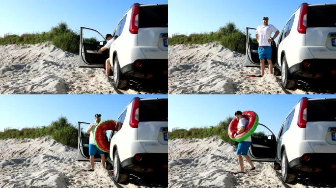 男子在沙滩上的脚蹼从车上出去