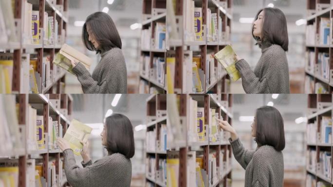 亚洲女学生从图书馆的书架上选书