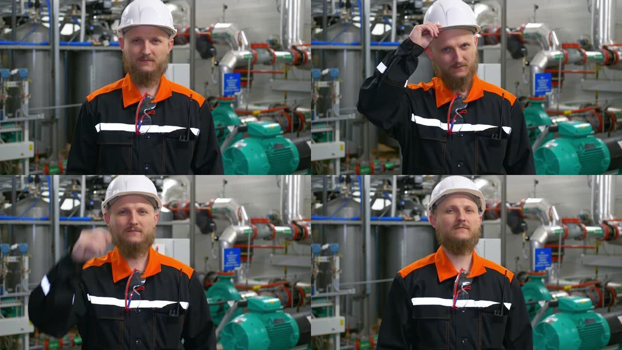 制造厂的工业工程师。一个戴着白色安全帽和工作服的大胡子男人在工作场所。在油气加工厂的油气结构中工作