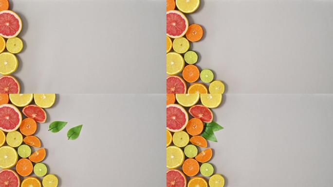 银色主题左侧切片健康新鲜柑橘类水果排列。停止运动平铺