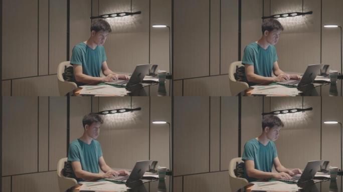 亚洲男子在家工作，使用笔记本电脑库存视频...