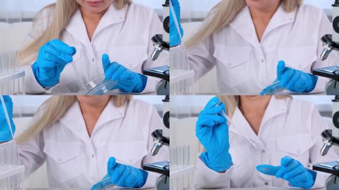 女科学家实验室助理使用微量移液器在大型现代实验室中填充试管，用于在显微镜下检查