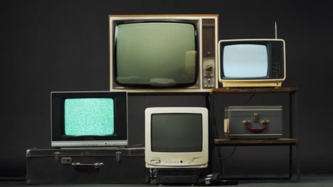 黑色背景上的复古旧电视。收集古老的老式电视，带有灰屏，信号接收不良，波纹和干扰，摄影概念