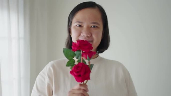 亚洲女子手捧玫瑰施舍