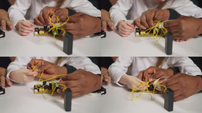 技术员教女孩用探针把电线连接到芯片上