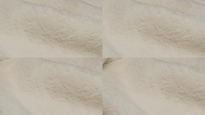 白色毛皮特写，羊毛。织物纹理背景。柔光保暖布的微距拍摄