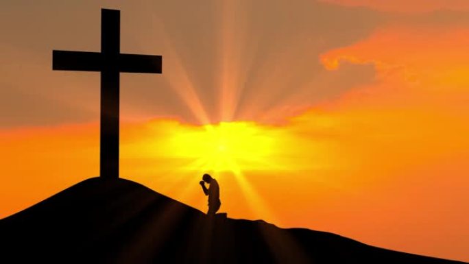 基督教男子在日落时向十字架祈祷