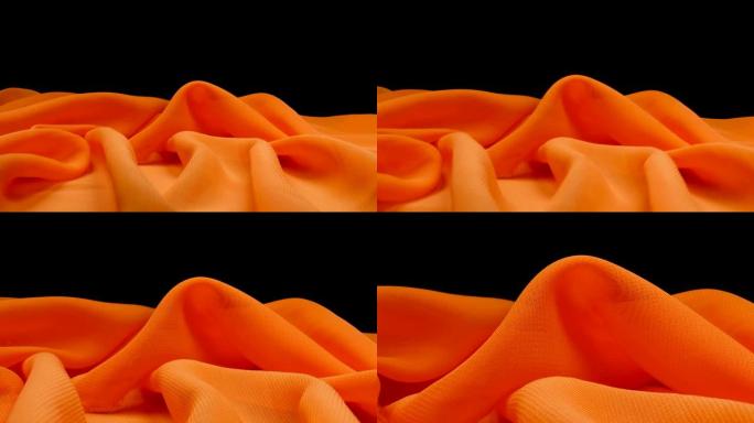 黑色背景的橙色画布上的微距相机移动