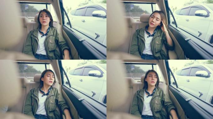 亚洲美女旅行者在城市旅行时坐在车里。迷人的年轻女性背包客感到悲伤和孤独，在泰国度假旅行中独自旅行。