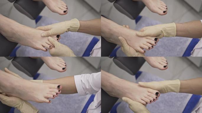 足病医生用手按摩手指，病人的脚