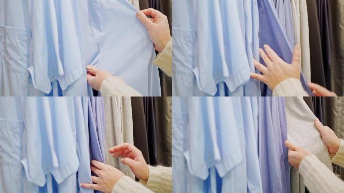 女性双手特写整理蓝色衣架上的男式衬衫