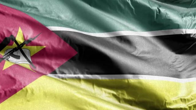 莫桑比克纺织旗帜在风中飘扬。莫桑比克的旗帜在微风中摇曳。面料纺织组织。完全填充背景。10秒循环。