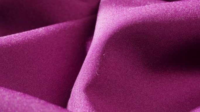 紫色面料特写，粉色缎面奢华布料纹理背景。豪华设计纺织品