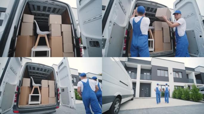搬迁公司的两名年轻工人将箱子和家具从小巴上卸下到客户家中
