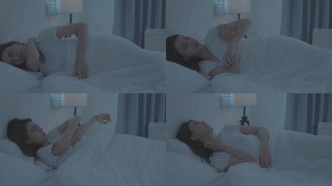 亚洲年轻女子睡觉时抓伤手感到过敏。美丽迷人的女孩躺在床上在卧室患有瘙痒的手臂皮肤过敏反应，昆虫叮咬，
