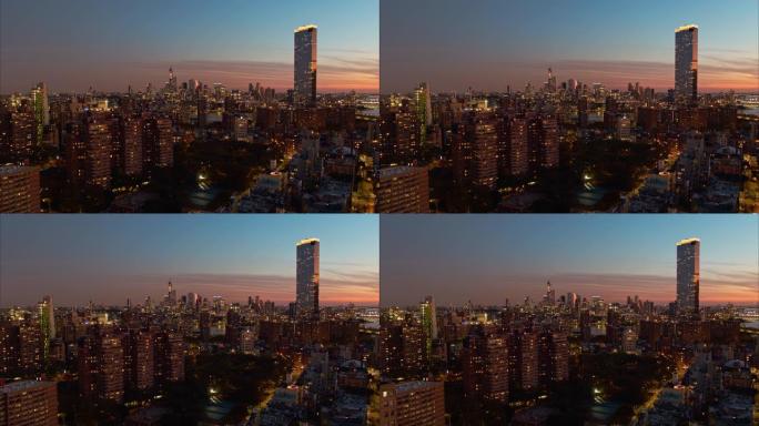 日落时纽约曼哈顿东区住宅区的全景。平移摄像机运动的航拍镜头。