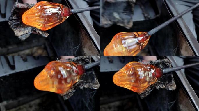艺术家制作玻璃艺术，吹制玻璃，使玻璃着火，