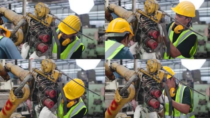 维修工程师正在修理一台在使用中损坏的机器。