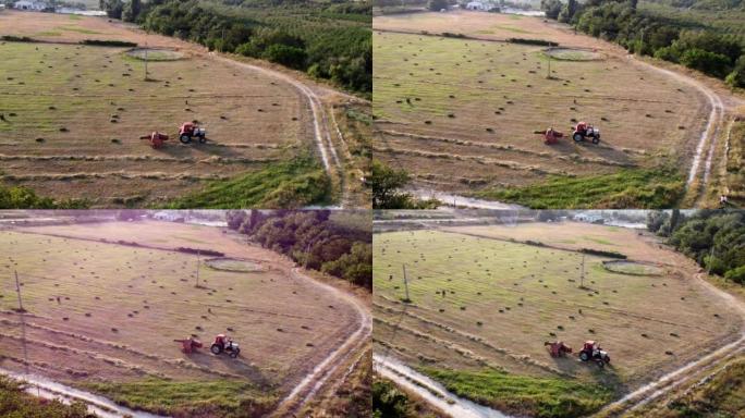拖拉机正在形成干草，在农田田地上成方捆，鸟瞰图。