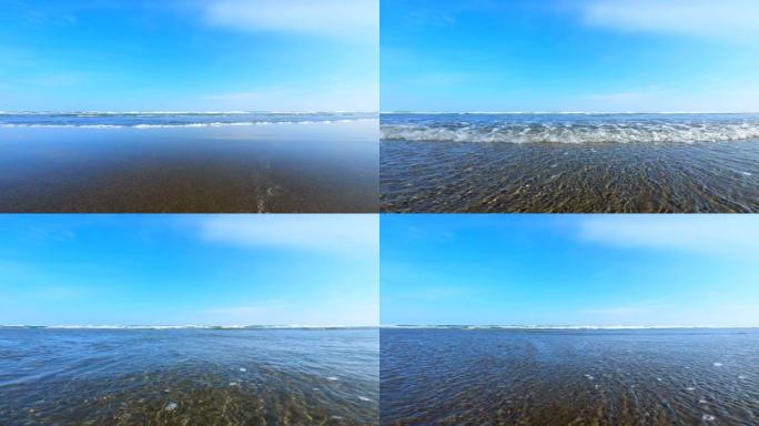 在海滩上飞溅波浪。海浪溅起相机