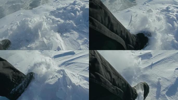 一个男人走在冰天雪地上。靴子踢到雪。美丽的冬天的风景。俄罗斯的自然地标。前视图。慢动作