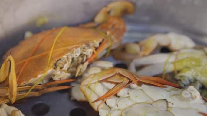 蓝色梭子蟹放在蒸汽锅上，刚刚吃完。蒸螃蟹。热。来自泰国的传统海鲜。泰国菜。