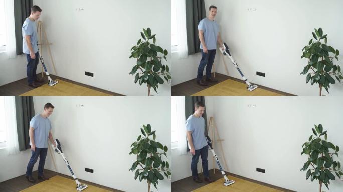 现代白色客厅用吸尘器清洁地板地毯的英俊白人男子