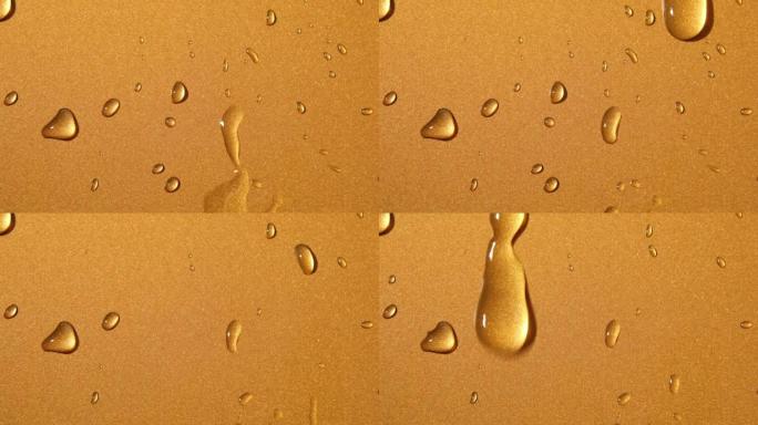 金青铜背景上的抽象水滴，宏观，气泡特写