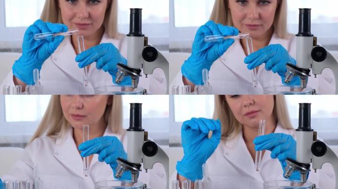 穿着医疗服和防护手套的女科学家实验室助理用试管在实验室显微镜下工作的样品进行研究