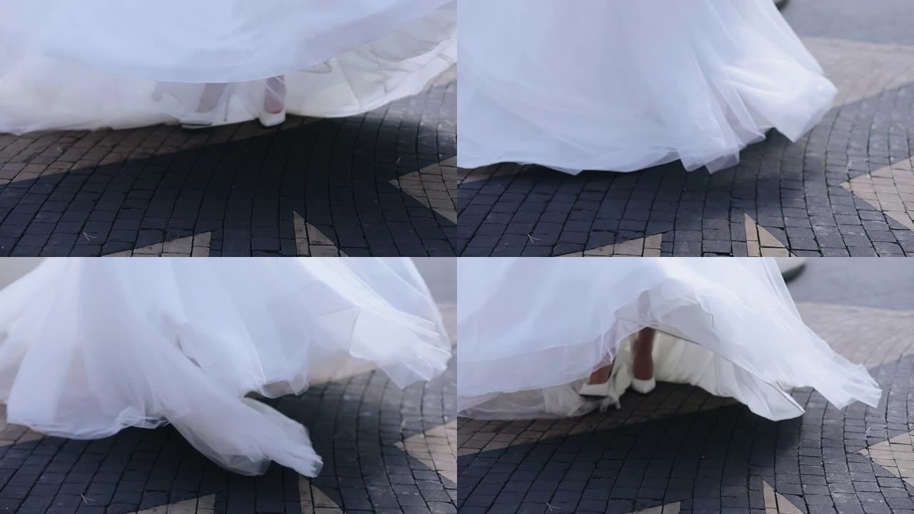 白色婚纱旋转下摆特写。新娘在街上跳舞