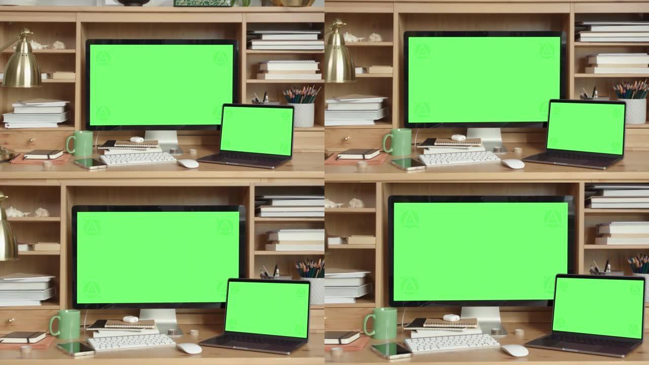 家用办公室内绿屏台式机和笔记本电脑